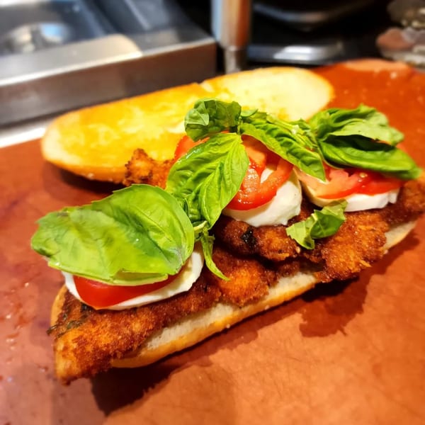 A Stallone's Italian Eatery chicken parmesan sandwich with fresh mozzarella, tomatoes, and basil.
