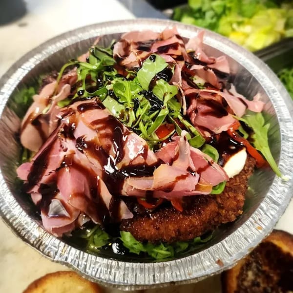Stallone's Italian Eatery's fried chicken cutlet topped with prosciutto, arugula, and balsamic glaze.